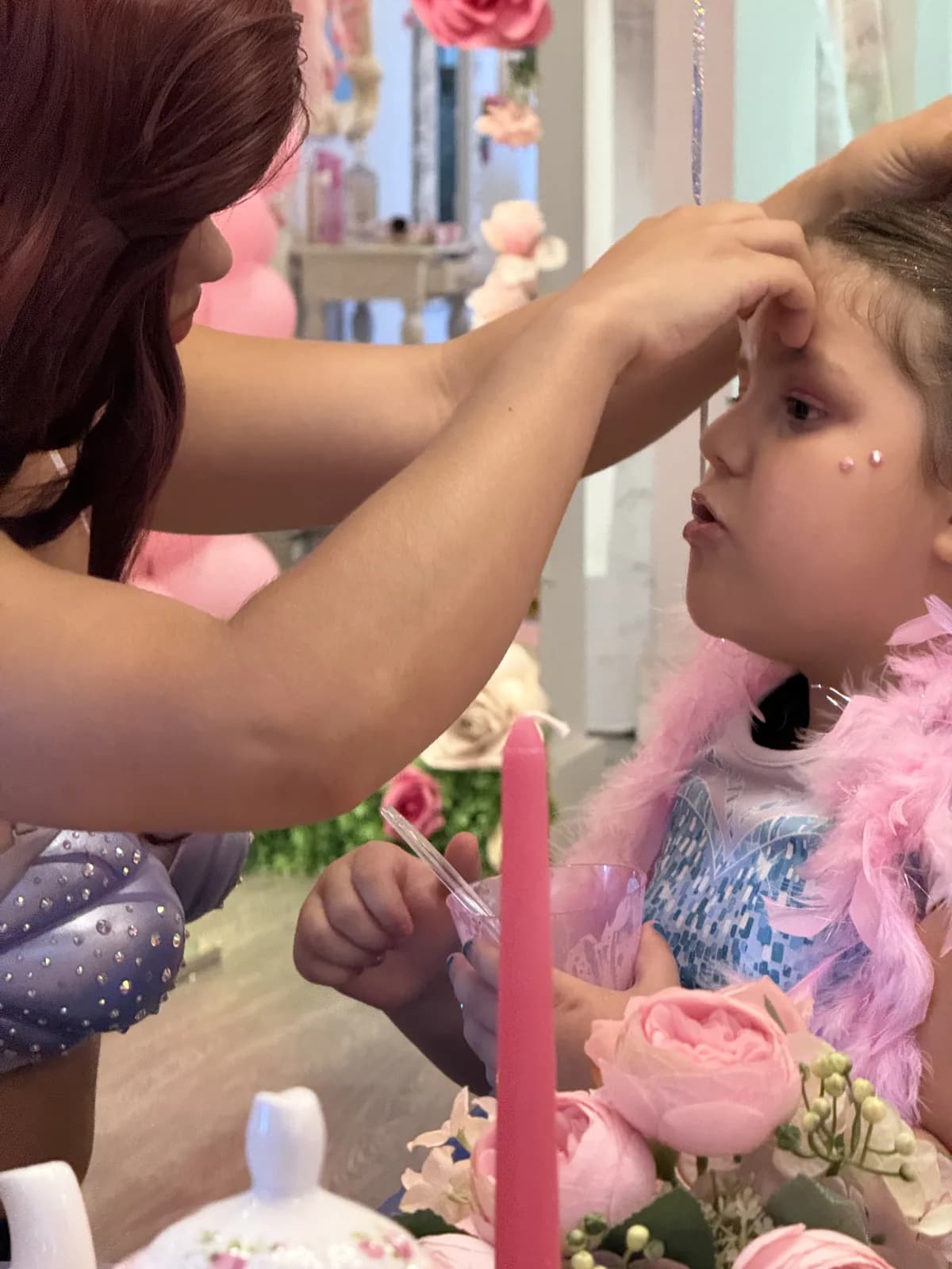 Face gems being applied at a princess spa birthday party in South Florida