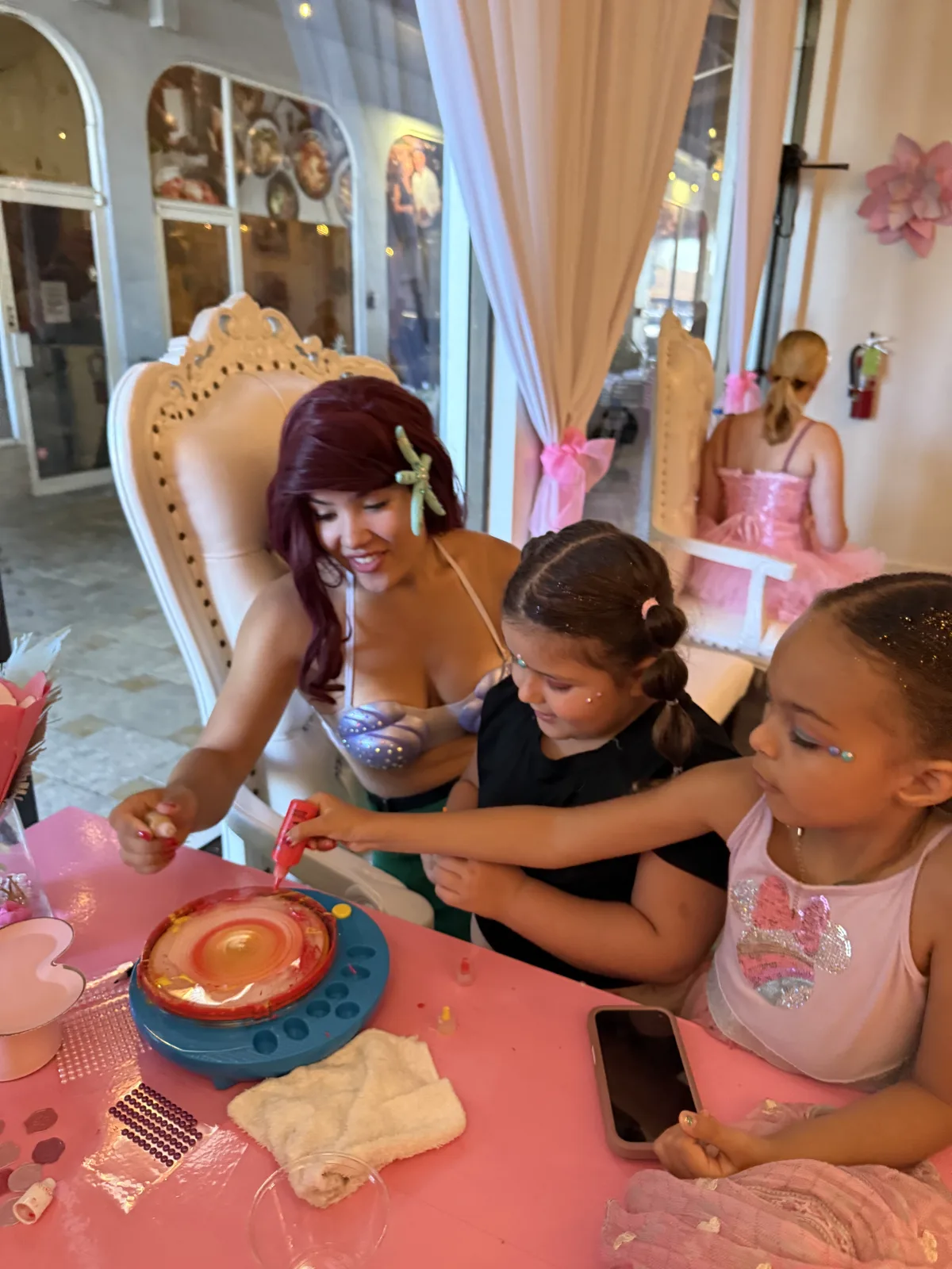 Ariel princess character doing spin art craft with girls at a Fort Lauderdale birthday party