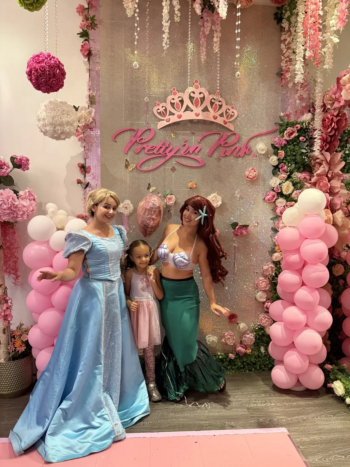 Birthday girl with Disney princess characters at a fully themed party in Fort Lauderdale