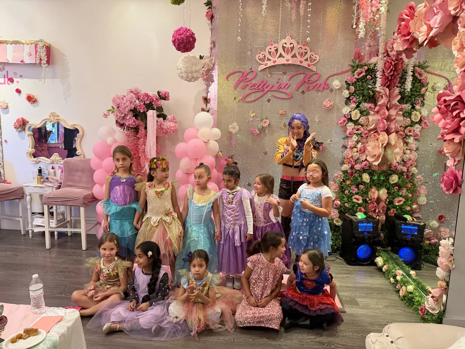 Girls in princess dresses group photo at Pretty in Pink Princess Spa sign Fort Lauderdale